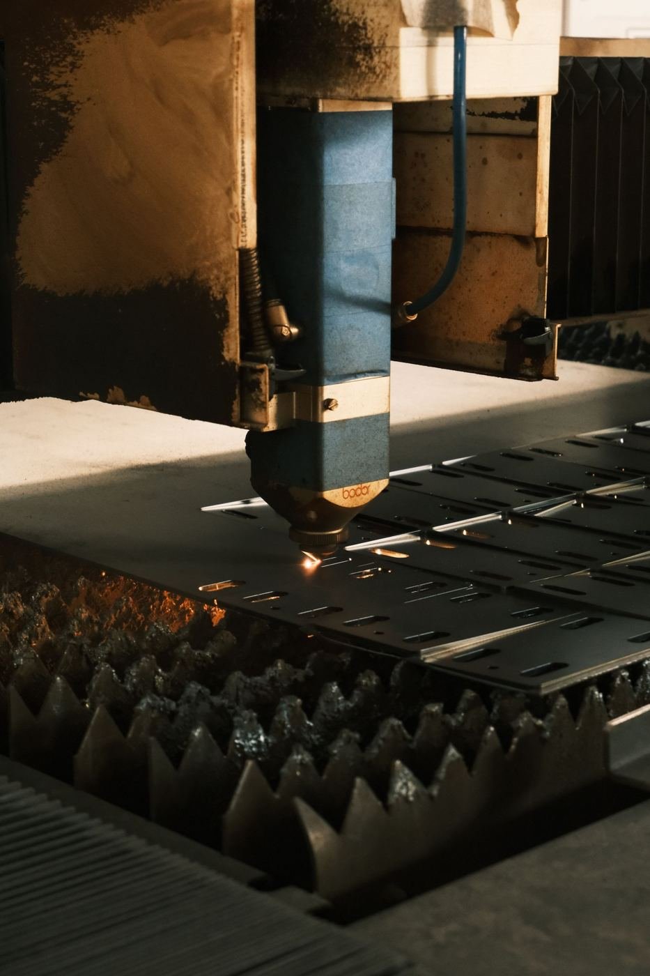Laser cutting head cutting a steel sheet